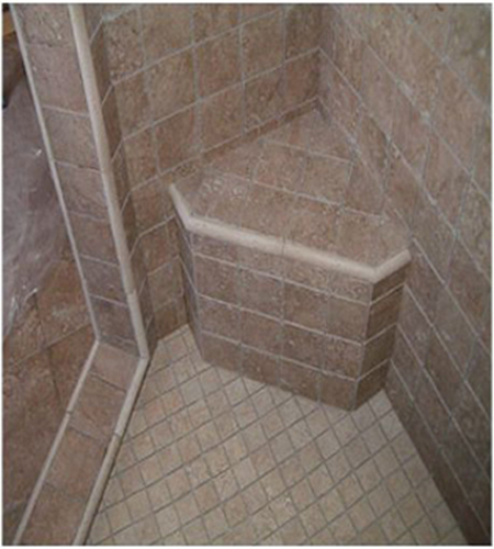 Shower with a seat, tiled with tumbled marble