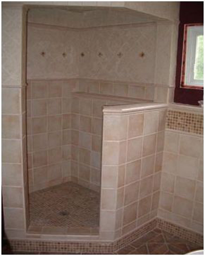 A tiled shower with design borders