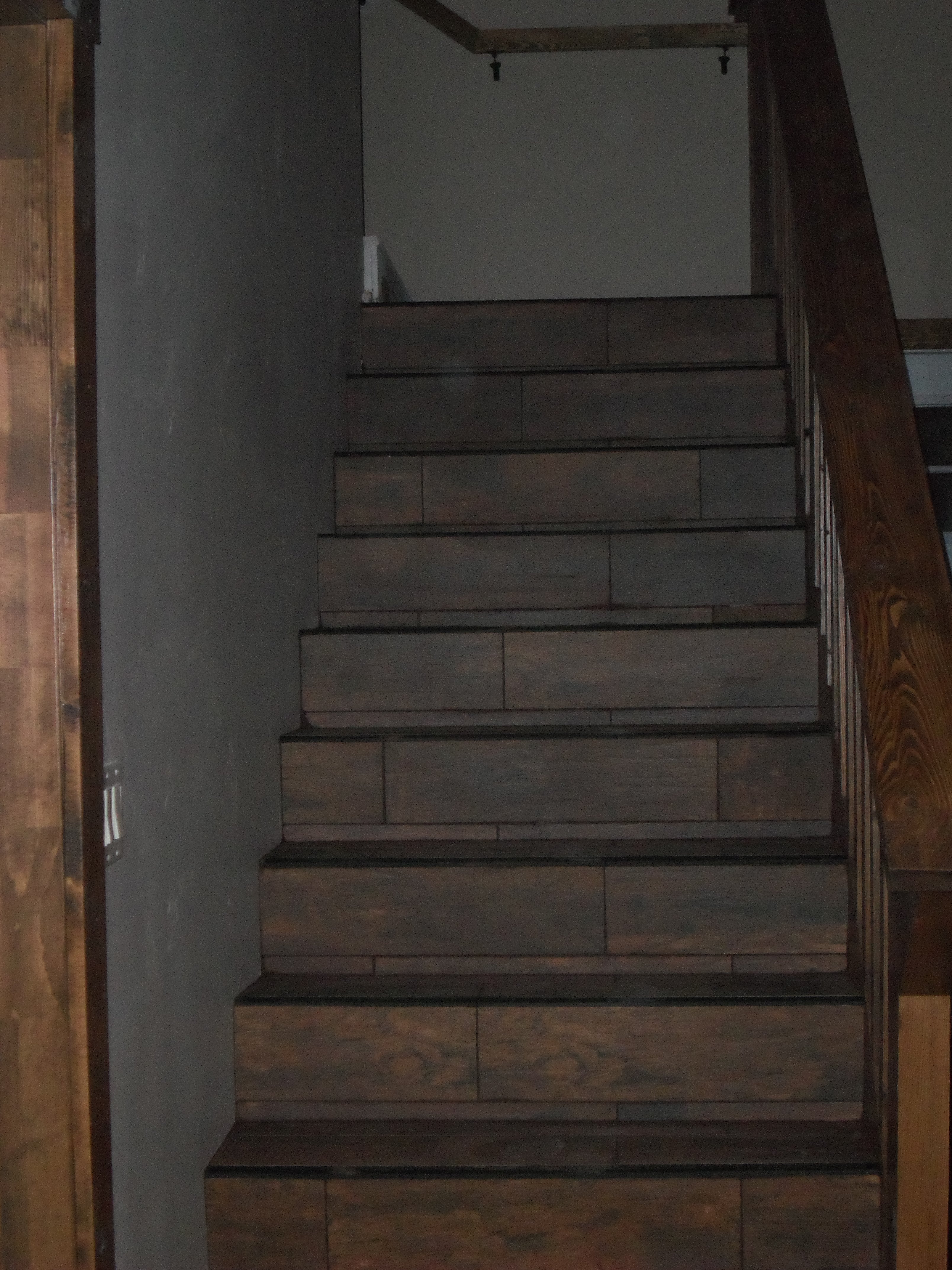 Staircase tiled with wood look planking tiles