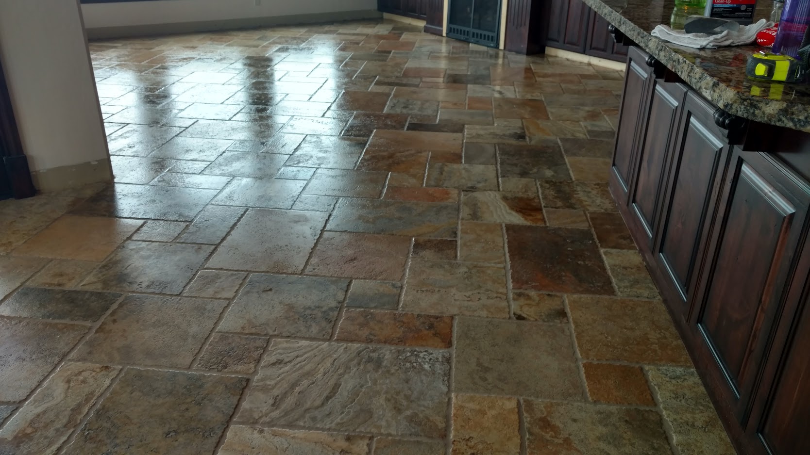 Kitchen floor tiled with slate in multiple sizes of tile