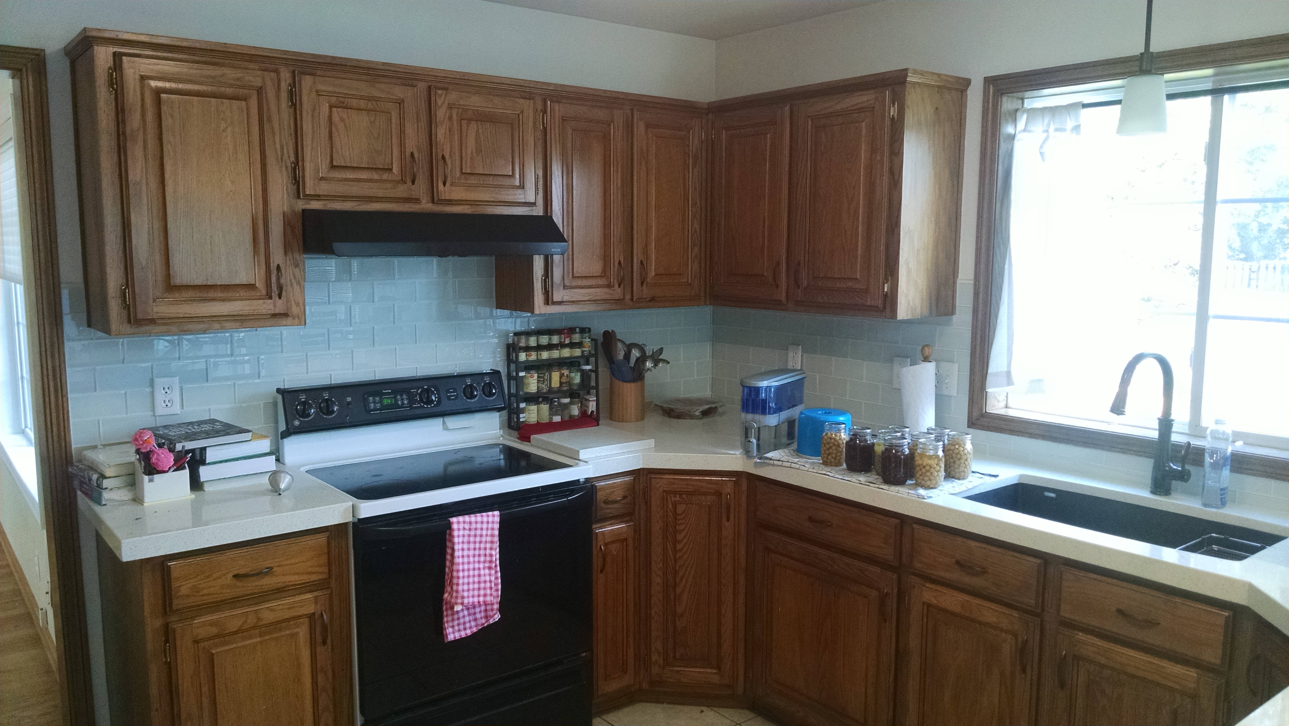 Kitchen backsplash tiled with white glass tiles