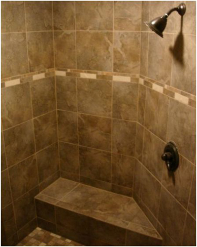 A tiled shower with design border