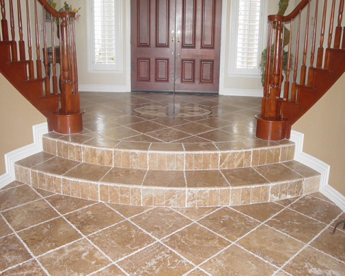 Tiled front entry and living room floor with decorative mural