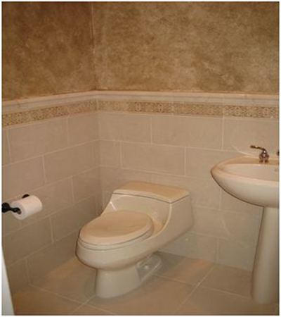 Bathroom with tiled wainscot and floor